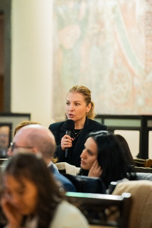 A person speaking into a microphone AI-generated content may be incorrect.